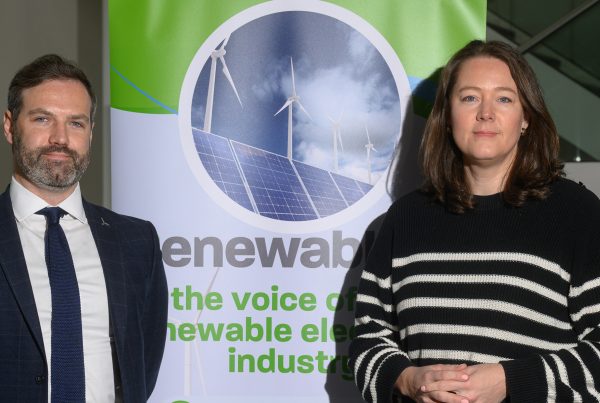 Mark Richardson and Steph Dunlop standing in from of RenewableNI sign