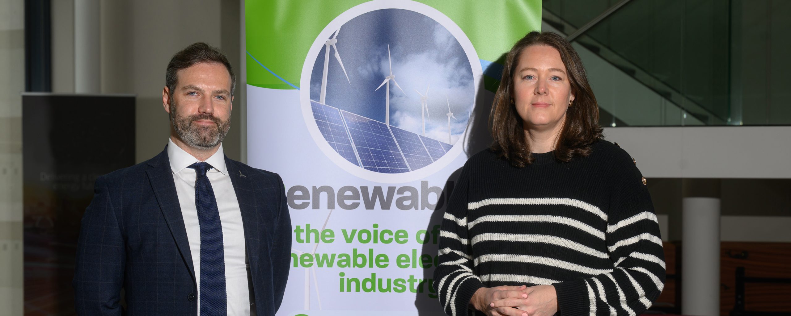 Mark Richardson and Steph Dunlop standing in from of RenewableNI sign